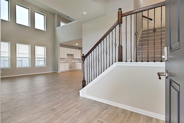 160 Majestic Shores Ln, La Porte, TX 77571 - stairway with wood finished floors, plenty of natural light, and a towering ceiling