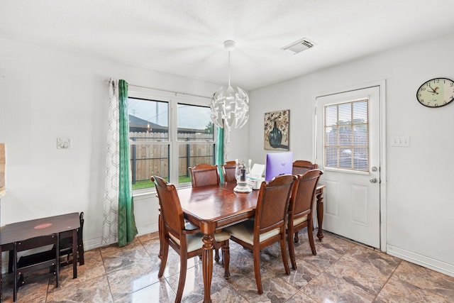 1126 Heathfield Dr, Channelview, TX 77530 - dining space featuring a chandelier and stone finish floors