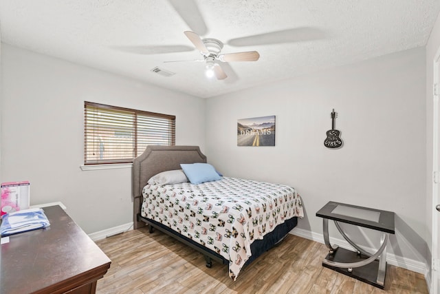 1126 Heathfield Dr, Channelview, TX 77530 - bedroom with light wood-type flooring, a textured ceiling, and ceiling fan