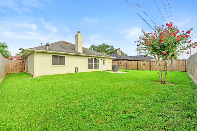 1126 Heathfield Dr, Channelview, TX 77530 - back of property with a fenced backyard, a chimney, a patio, and stucco siding