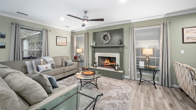 21215 Kelliwood Greens Dr, Katy, TX 77450 - living room with light wood-style floors, crown molding, a premium fireplace, a ceiling fan, and recessed lighting