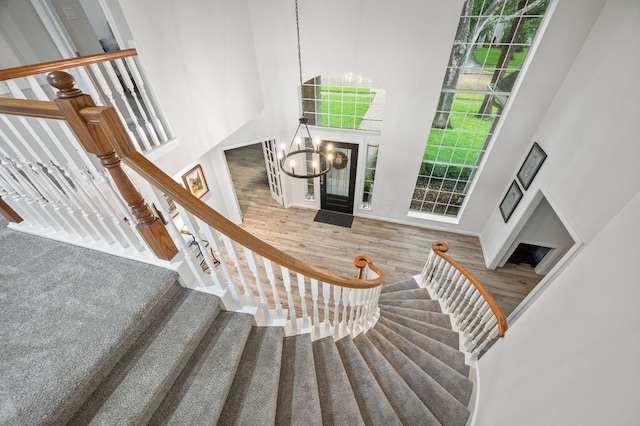 21215 Kelliwood Greens Dr, Katy, TX 77450 - stairway with a towering ceiling, a chandelier, and wood finished floors