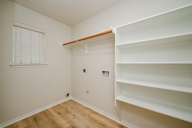 2046 Grand Park Dr, Missouri City, TX 77489 - washroom with hookup for an electric dryer, light wood-style floors, washer hookup, and hookup for a gas dryer