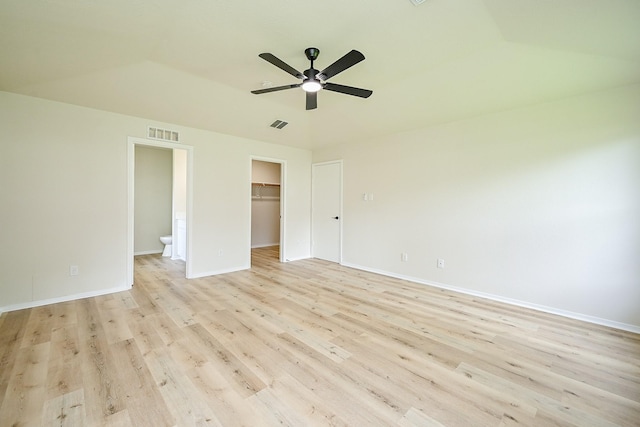 2046 Grand Park Dr, Missouri City, TX 77489 - unfurnished bedroom featuring light wood finished floors, a spacious closet, lofted ceiling, and ceiling fan