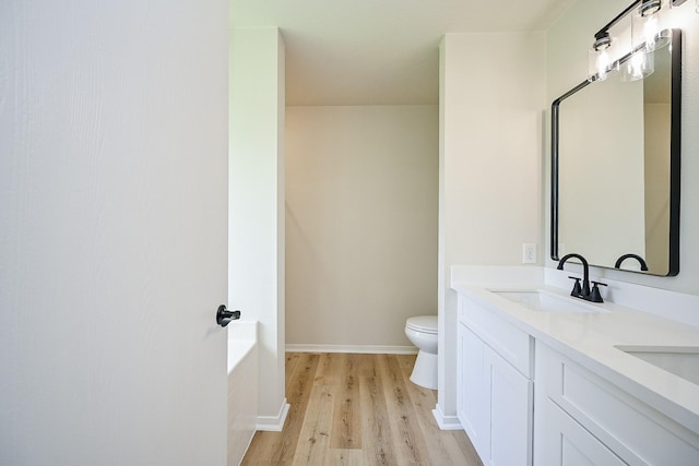 2046 Grand Park Dr, Missouri City, TX 77489 - bathroom with wood finished floors, double vanity, and a tub