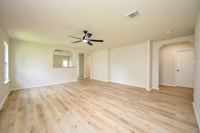2046 Grand Park Dr, Missouri City, TX 77489 - unfurnished room featuring arched walkways, a ceiling fan, and light wood-style flooring