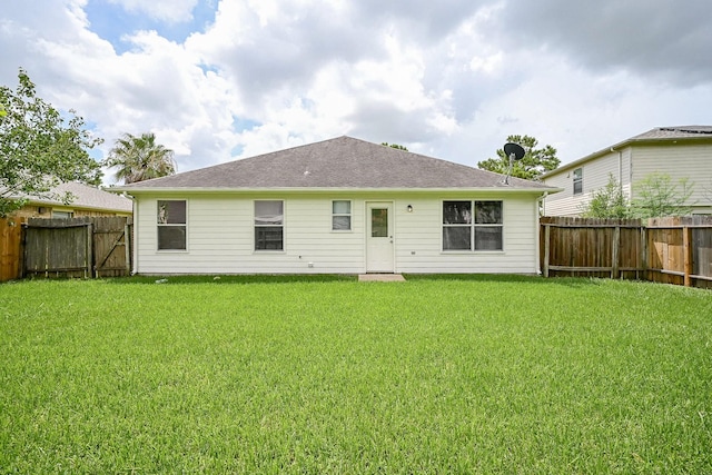 2046 Grand Park Dr, Missouri City, TX 77489 - back of property with a fenced backyard and a shingled roof