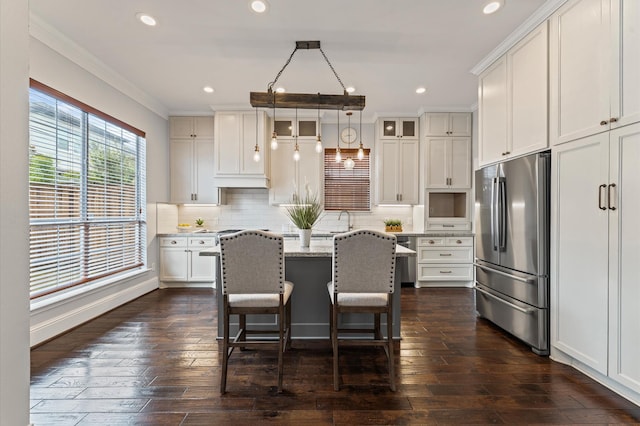 4303 Jonathan St, Bellaire, TX 77401 - kitchen featuring freestanding refrigerator, ornamental molding, glass insert cabinets, white cabinets, and dark wood-style flooring