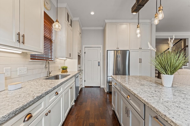 4303 Jonathan St, Bellaire, TX 77401 - kitchen featuring appliances with stainless steel finishes, light stone countertops, ornamental molding, hanging light fixtures, and recessed lighting