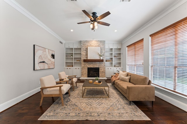 4303 Jonathan St, Bellaire, TX 77401 - living room featuring ornamental molding, built in features, dark wood-style flooring, ceiling fan, and a stone fireplace