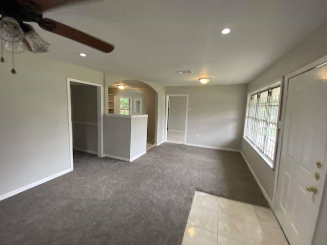 5322 Dewberry St, Houston, TX 77021 - unfurnished living room with arched walkways, carpet floors, plenty of natural light, a ceiling fan, and recessed lighting
