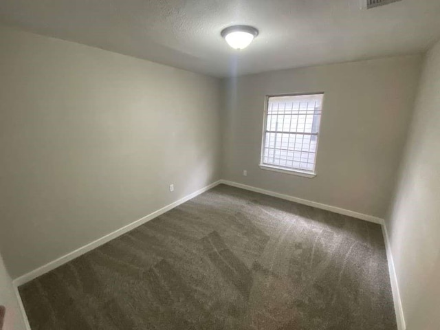 5322 Dewberry St, Houston, TX 77021 - empty room featuring dark carpet and baseboards