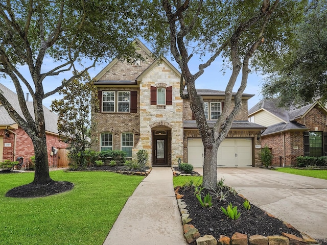 28111 Harper Creek Ln, Katy, TX 77494 - view of front of property with concrete driveway, a front yard, an attached garage, brick siding, and stone siding