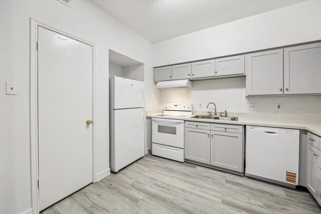 2100 Tanglewilde St Unit 360, Houston, TX 77063 - kitchen featuring white appliances, under cabinet range hood, light wood finished floors, light countertops, and gray cabinetry