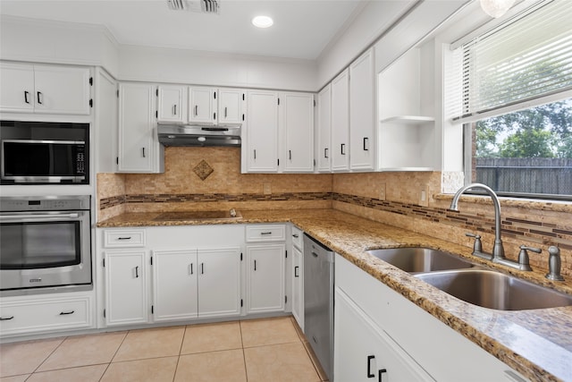 3808 Montego Dr, Baytown, TX 77521 - kitchen featuring stainless steel appliances, under cabinet range hood, light tile patterned flooring, white cabinetry, and ornamental molding