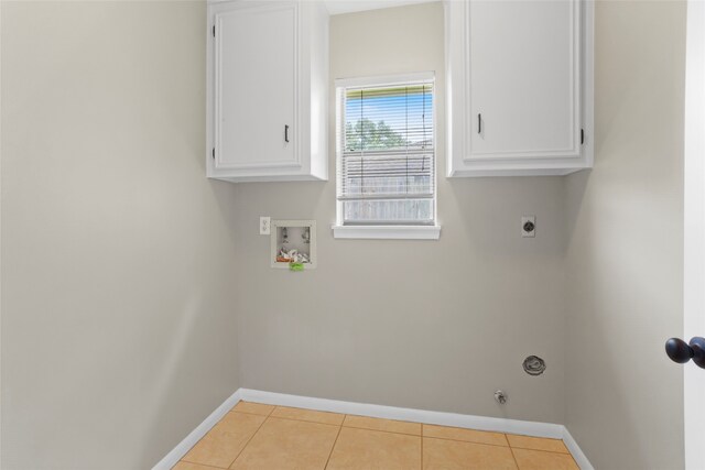 3808 Montego Dr, Baytown, TX 77521 - laundry area featuring hookup for a washing machine, electric dryer hookup, cabinet space, and light tile patterned floors