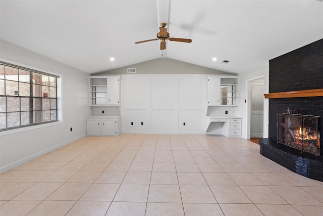 3808 Montego Dr, Baytown, TX 77521 - unfurnished living room with ceiling fan, lofted ceiling, a brick fireplace, a desk, and light tile patterned floors