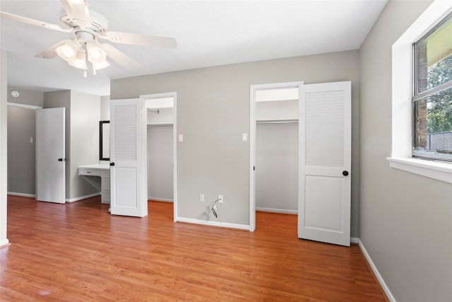 3808 Montego Dr, Baytown, TX 77521 - unfurnished bedroom featuring a walk in closet, light wood-style flooring, and a ceiling fan