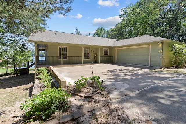 386 Dailey Rd, Crockett, TX 75835 - ranch-style house with an attached garage, a porch, concrete driveway, and roof with shingles