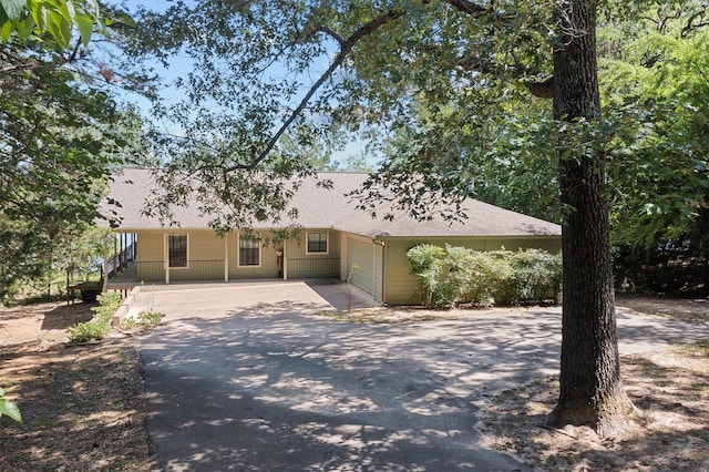386 Dailey Rd, Crockett, TX 75835 - view of front of house with concrete driveway, a garage, and a shingled roof