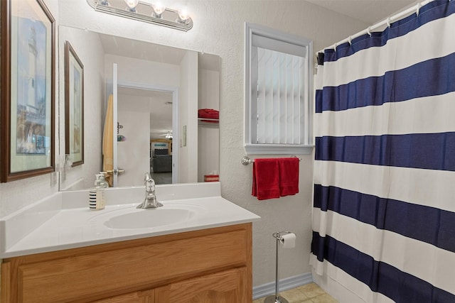 386 Dailey Rd, Crockett, TX 75835 - bathroom with vanity, a textured wall, curtained shower, and tile patterned floors
