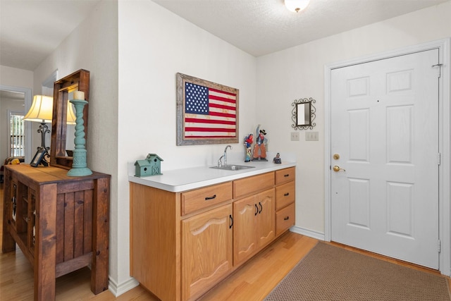 386 Dailey Rd, Crockett, TX 75835 - bar area with light wood-type flooring and a sink