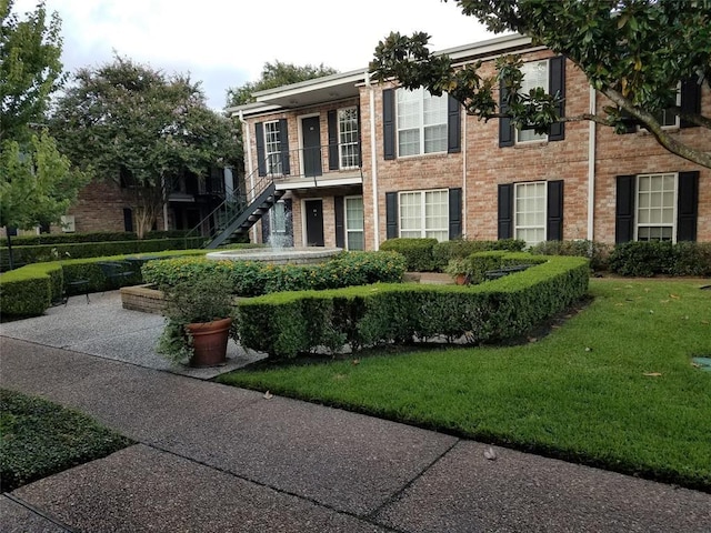6410 Del Monte Dr Unit 118, Houston, TX 77057 - view of property featuring a front yard, stairway, and brick siding