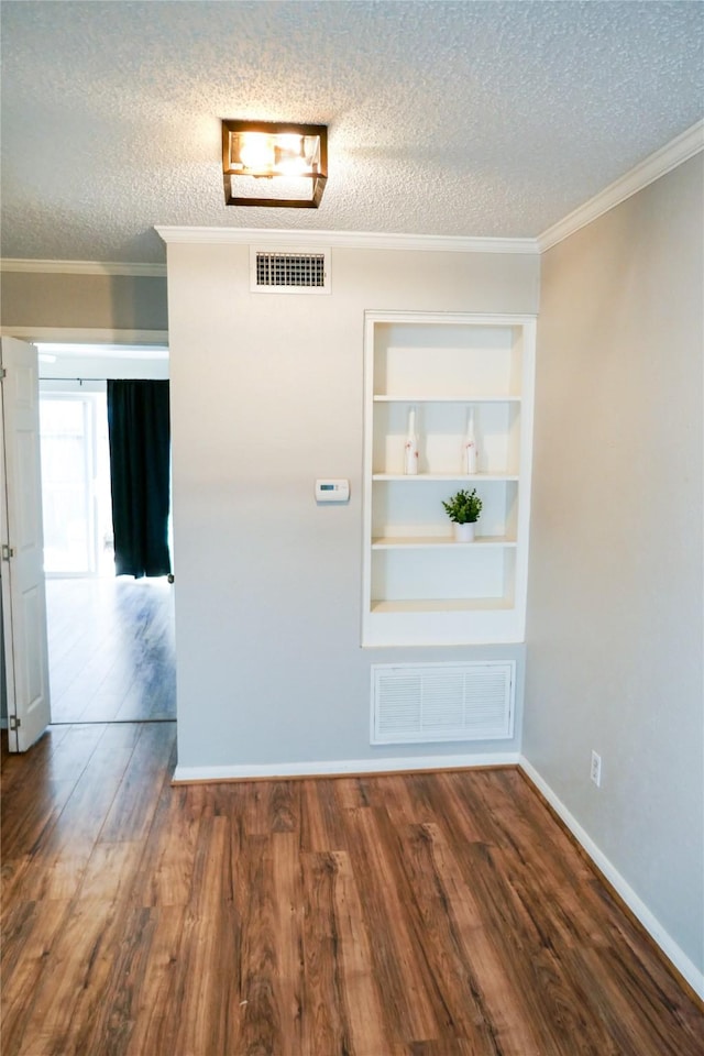 6410 Del Monte Dr Unit 118, Houston, TX 77057 - spare room featuring a textured ceiling, wood finished floors, built in features, and ornamental molding