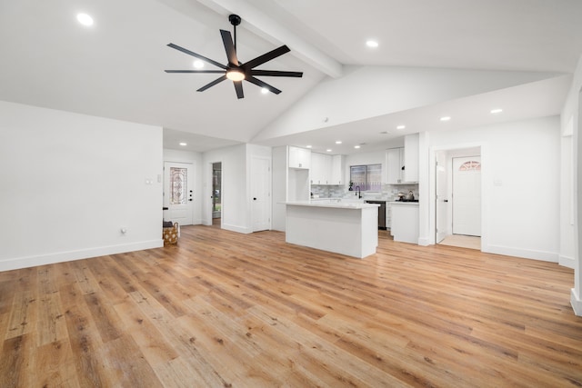 9030 Tanager St, Houston, TX 77036 - unfurnished living room featuring ceiling fan, beamed ceiling, light wood-style flooring, recessed lighting, and high vaulted ceiling