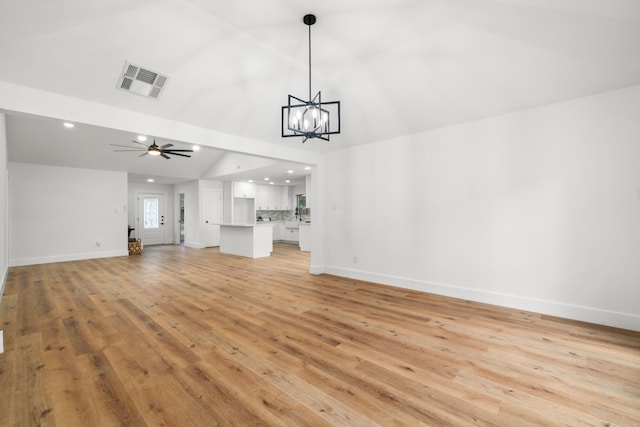 9030 Tanager St, Houston, TX 77036 - unfurnished living room featuring light wood-type flooring, ceiling fan, vaulted ceiling, a chandelier, and recessed lighting