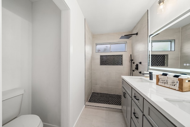 9030 Tanager St, Houston, TX 77036 - bathroom with healthy amount of natural light, double vanity, a tile shower, and marble finish floors