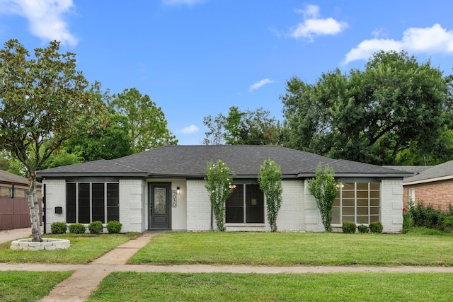9030 Tanager St, Houston, TX 77036 - ranch-style house with a front yard, brick siding, and roof with shingles
