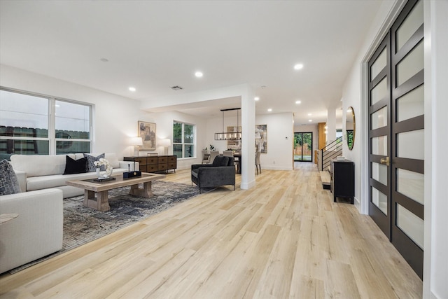 5005 Chestnut St, Bellaire, TX 77401 - living room featuring light wood-style flooring, recessed lighting, and stairway