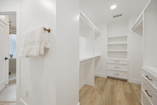 5005 Chestnut St, Bellaire, TX 77401 - walk in closet with light wood-type flooring