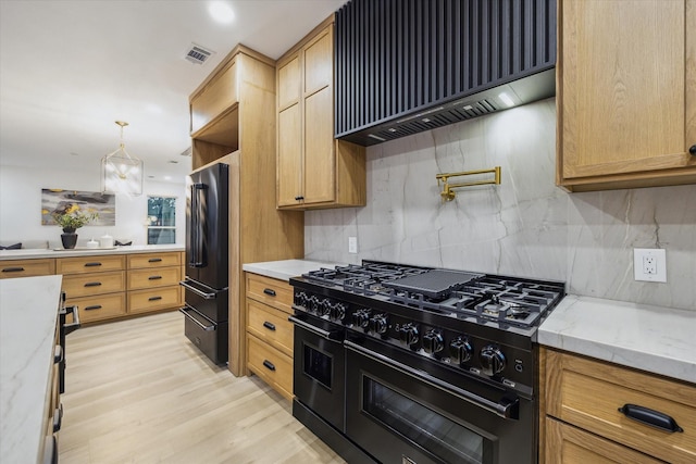 5005 Chestnut St, Bellaire, TX 77401 - kitchen featuring black appliances, custom exhaust hood, decorative backsplash, light stone countertops, and light wood-type flooring