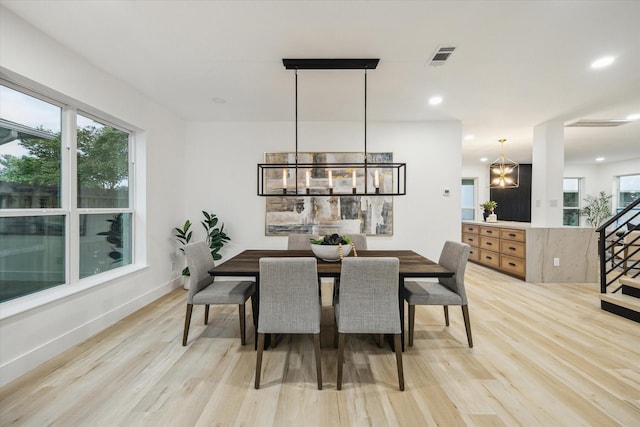 5005 Chestnut St, Bellaire, TX 77401 - dining area featuring a chandelier, light wood-style flooring, stairs, and recessed lighting