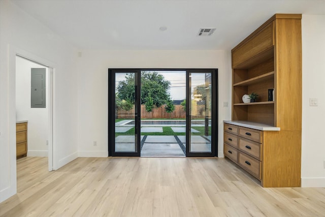 5005 Chestnut St, Bellaire, TX 77401 - doorway featuring electric panel and light wood-style floors