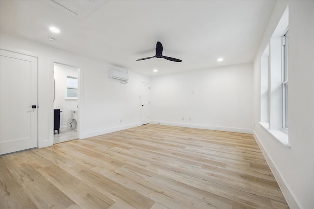 5005 Chestnut St, Bellaire, TX 77401 - empty room with an AC wall unit, a ceiling fan, recessed lighting, and light wood-type flooring