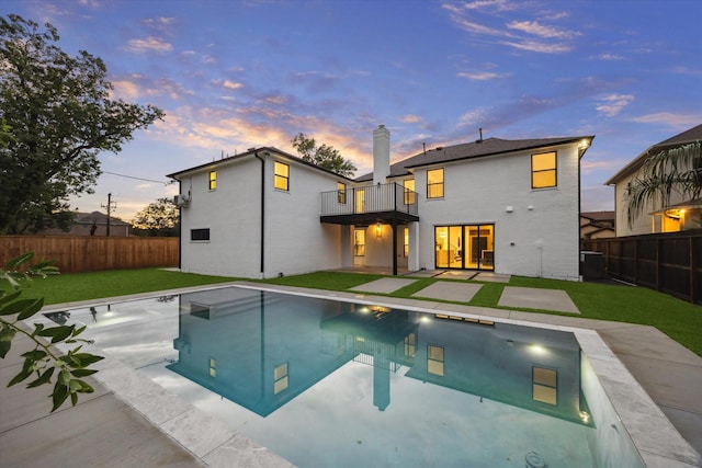 5005 Chestnut St, Bellaire, TX 77401 - back of house with a balcony, a fenced backyard, a chimney, and a patio