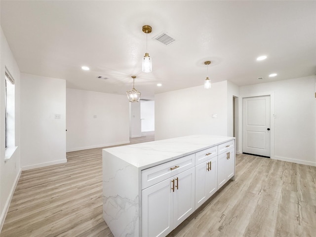 14214 Morinscott, Houston, TX 77049 - kitchen featuring light wood-style flooring, recessed lighting, pendant lighting, white cabinets, and a center island