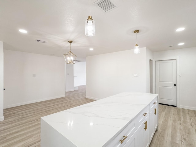 14214 Morinscott, Houston, TX 77049 - kitchen with light wood finished floors, pendant lighting, recessed lighting, white cabinetry, and light stone countertops