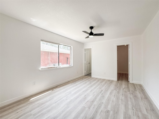 14214 Morinscott, Houston, TX 77049 - unfurnished bedroom featuring light wood finished floors, a ceiling fan, and a spacious closet