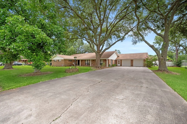8105 Miller Dr, Hitchcock, TX 77563 - view of front facade with driveway, a garage, a front lawn, and brick siding
