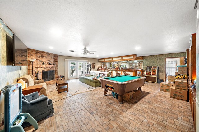 8105 Miller Dr, Hitchcock, TX 77563 - playroom featuring brick patterned floors, a brick fireplace, billiards table, ceiling fan, and recessed lighting