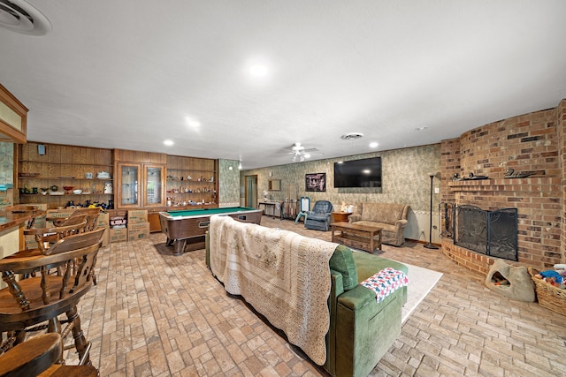 8105 Miller Dr, Hitchcock, TX 77563 - living room with brick patterned floors, a fireplace, pool table, ceiling fan, and recessed lighting
