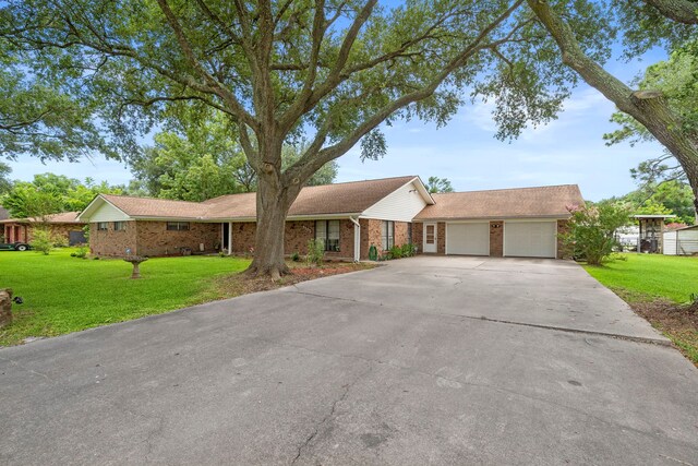 8105 Miller Dr, Hitchcock, TX 77563 - view of front of property featuring brick siding, a front yard, concrete driveway, and an attached garage