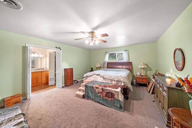 8105 Miller Dr, Hitchcock, TX 77563 - bedroom featuring light carpet, ensuite bathroom, and ceiling fan