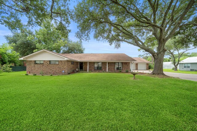 8105 Miller Dr, Hitchcock, TX 77563 - ranch-style house with driveway and brick siding
