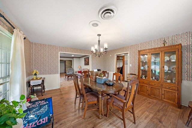 8105 Miller Dr, Hitchcock, TX 77563 - dining space featuring wallpapered walls, a chandelier, and light wood-style flooring