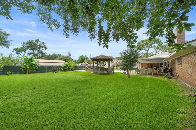 8105 Miller Dr, Hitchcock, TX 77563 - fenced backyard with a gazebo, an outdoor living space, and a patio area